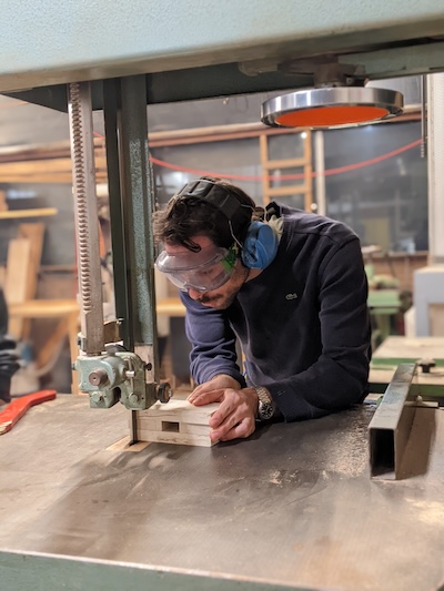 A woodworker shaping a piece by hand